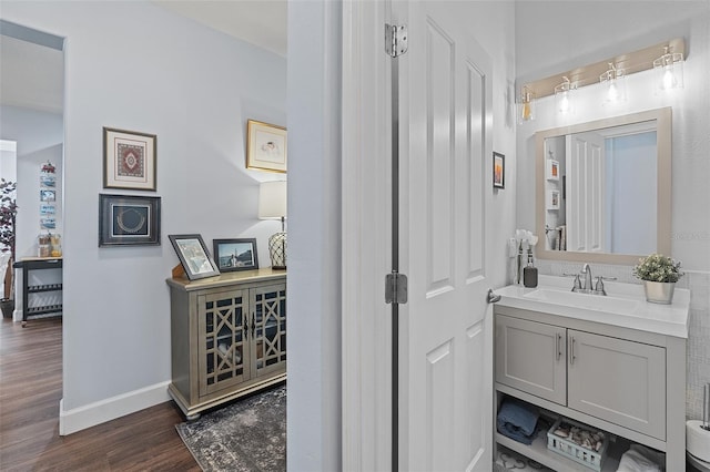 3304 Cat Brier Trl, Harmony, FL 34773 - bathroom featuring baseboards, wood finished floors, and vanity