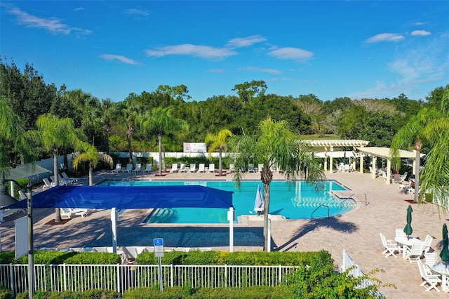 3304 Cat Brier Trl, Harmony, FL 34773 - community pool with fence, a pergola, and a patio