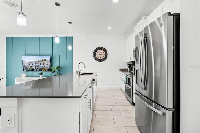 kitchen featuring stainless steel appliances, dark countertops, a sink, and visible vents