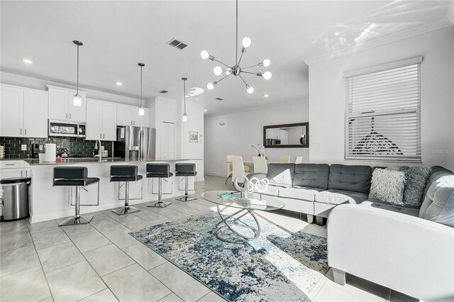 living room featuring light tile patterned floors, recessed lighting, a notable chandelier, visible vents, and crown molding