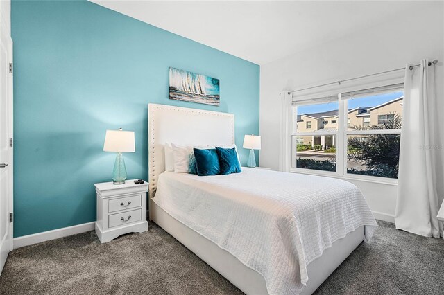 bedroom with carpet floors and baseboards