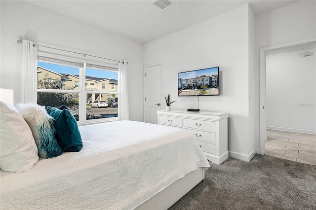 bedroom featuring light carpet, baseboards, and visible vents