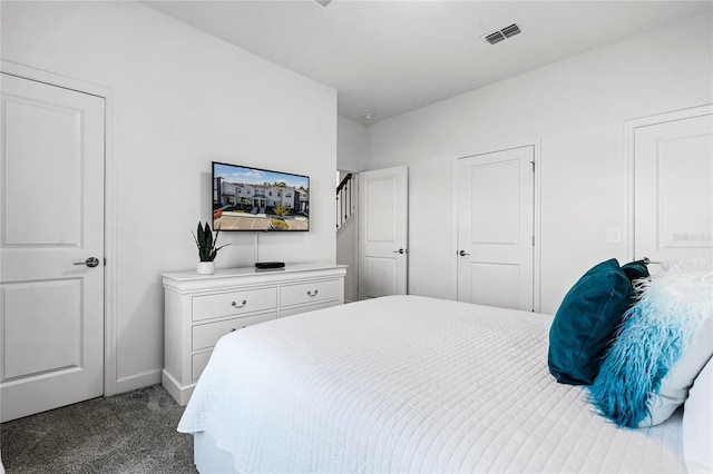 carpeted bedroom featuring visible vents and baseboards