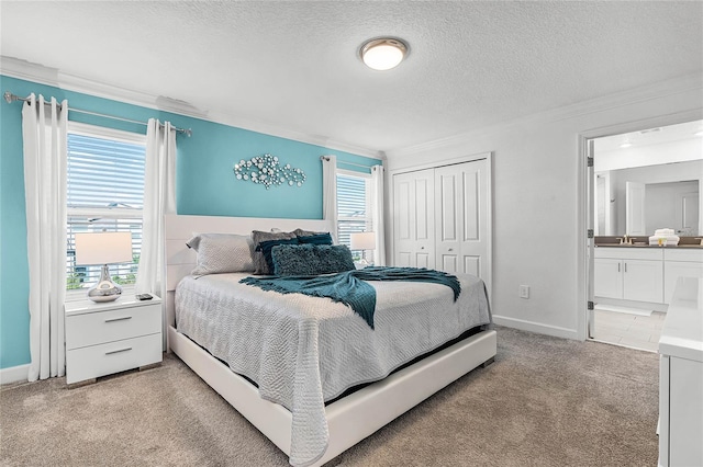 bedroom featuring crown molding, a closet, light carpet, a textured ceiling, and baseboards