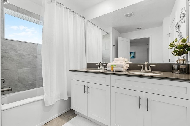 bathroom with shower / tub combo, tile patterned flooring, visible vents, and a sink