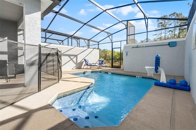 outdoor pool with glass enclosure and a patio area