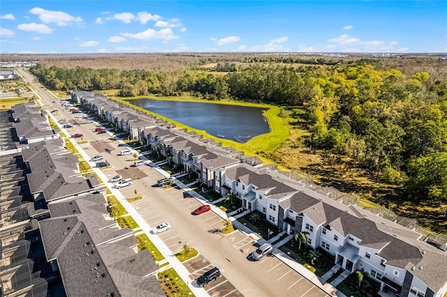 birds eye view of property with a water view, a wooded view, and a residential view