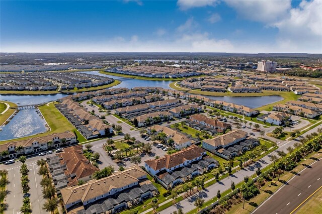 drone / aerial view with a water view and a residential view