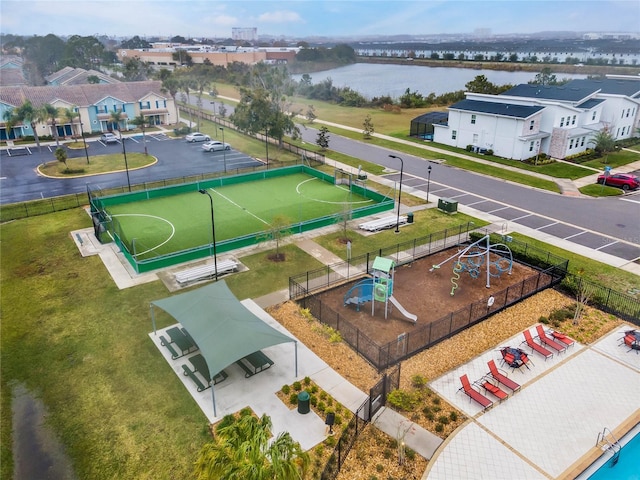 birds eye view of property featuring a water view and a residential view