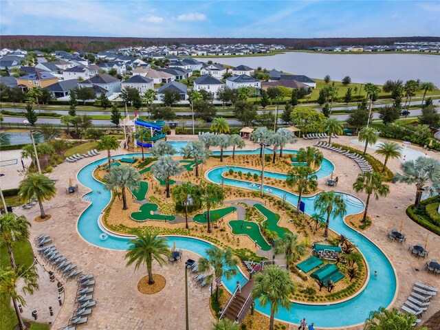 drone / aerial view with a water view and a residential view