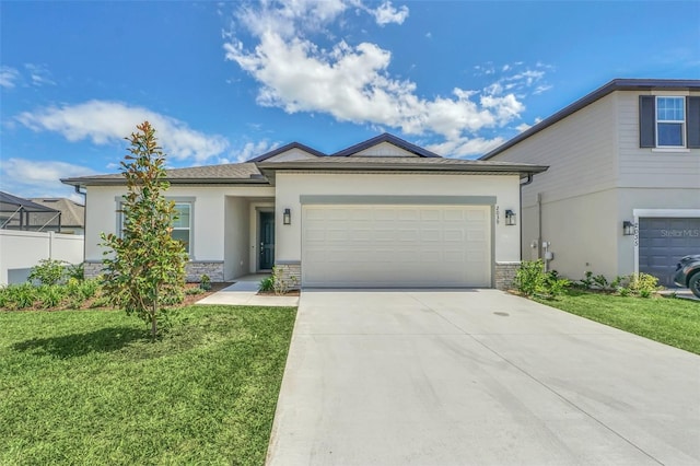 view of front of home featuring an attached garage, driveway, a front lawn, and stucco siding