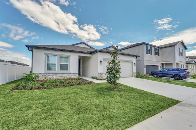 view of front of home with a front yard, fence, driveway, stucco siding, and stone siding