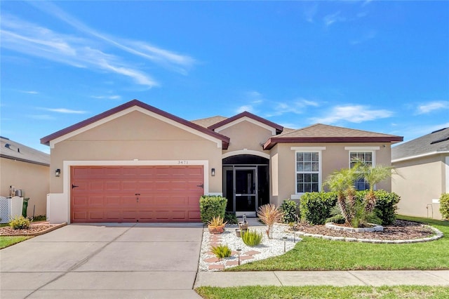 view of front of property with stucco siding, driveway, and a garage