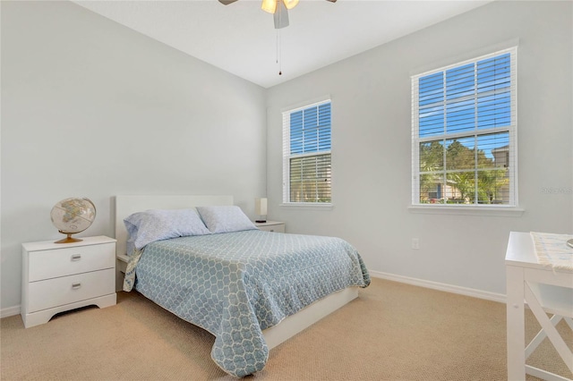 bedroom featuring light carpet, ceiling fan, and baseboards