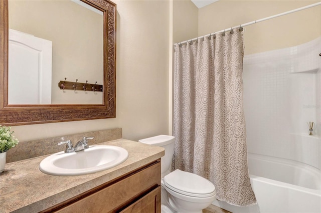 bathroom featuring vanity, shower / tub combo, and toilet