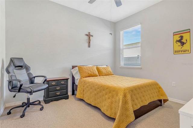 bedroom with light colored carpet, a ceiling fan, and baseboards