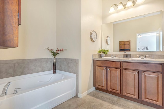 full bath featuring a garden tub, tile patterned floors, and a sink