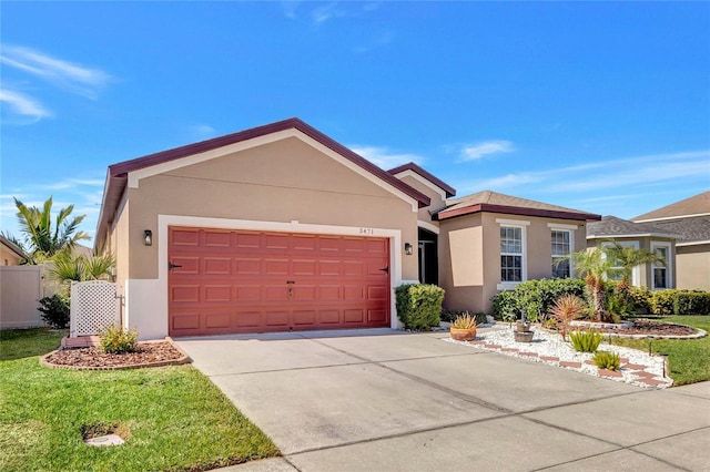 ranch-style home featuring concrete driveway, a front lawn, a garage, and stucco siding