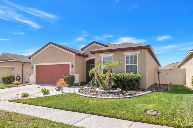 single story home featuring a front lawn, stucco siding, a garage, driveway, and a gate