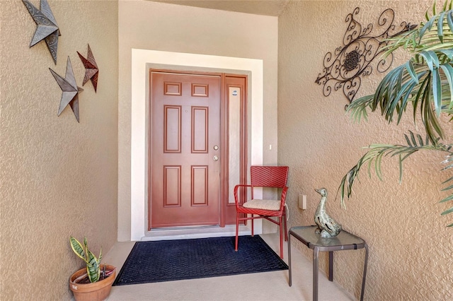 entrance to property with stucco siding