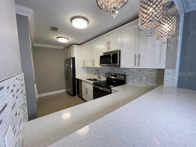 kitchen featuring light countertops, visible vents, backsplash, a sink, and black appliances