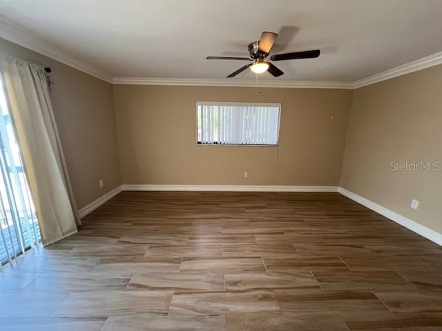 spare room with ornamental molding, ceiling fan, baseboards, and wood finished floors