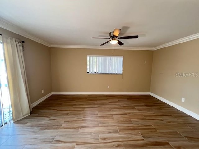 empty room with baseboards, wood tiled floor, ornamental molding, and a ceiling fan