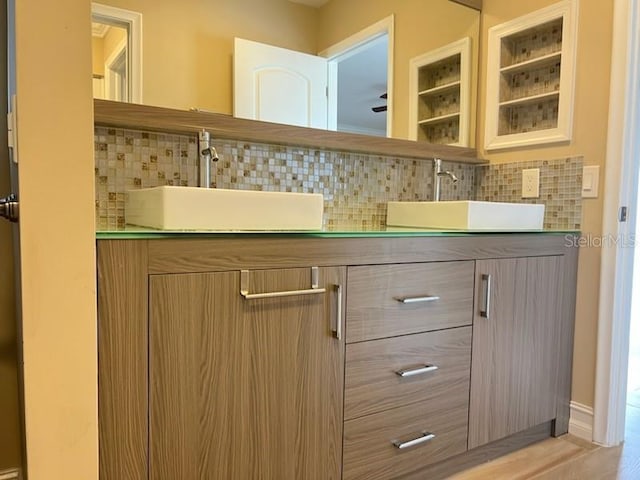 bar featuring a sink and backsplash