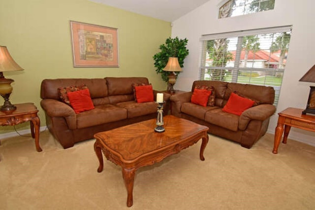 living room with lofted ceiling and light carpet