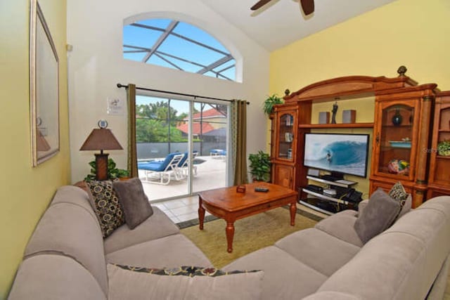 tiled living room featuring a ceiling fan and high vaulted ceiling