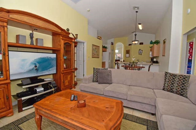 living room featuring lofted ceiling and arched walkways