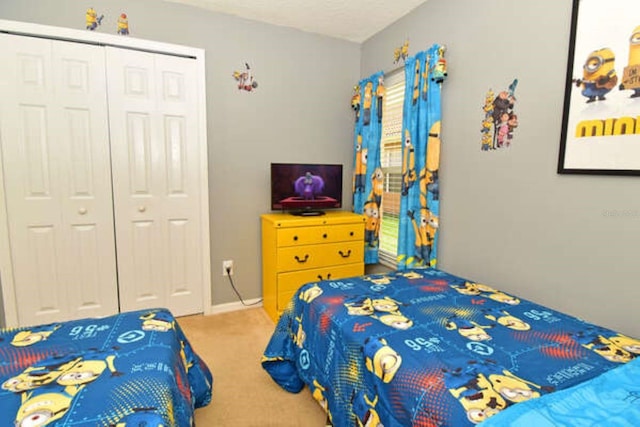 carpeted bedroom featuring a closet