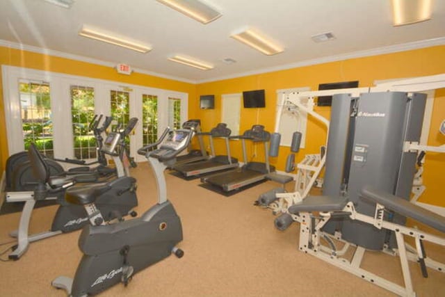 gym featuring french doors, ornamental molding, and visible vents