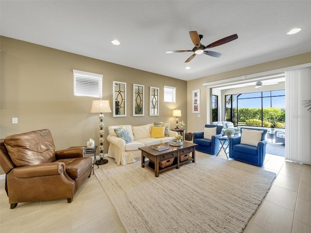 living area with a sunroom, light tile patterned flooring, a ceiling fan, and recessed lighting