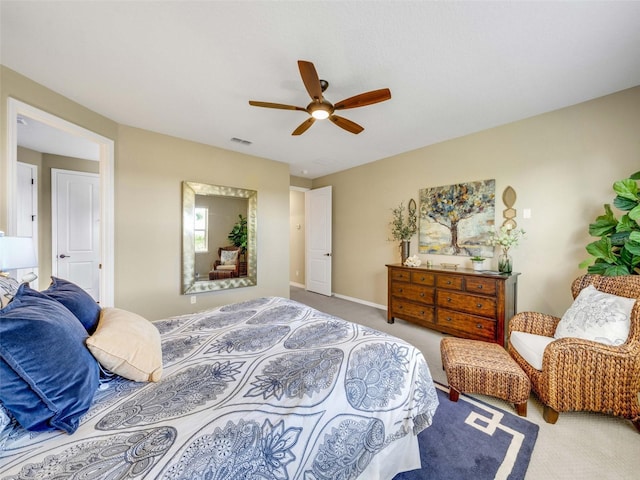 bedroom with carpet floors, baseboards, visible vents, and a ceiling fan