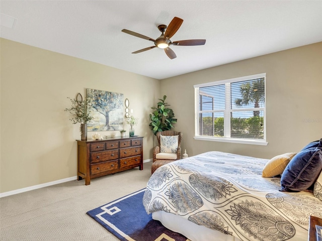 carpeted bedroom featuring a ceiling fan and baseboards