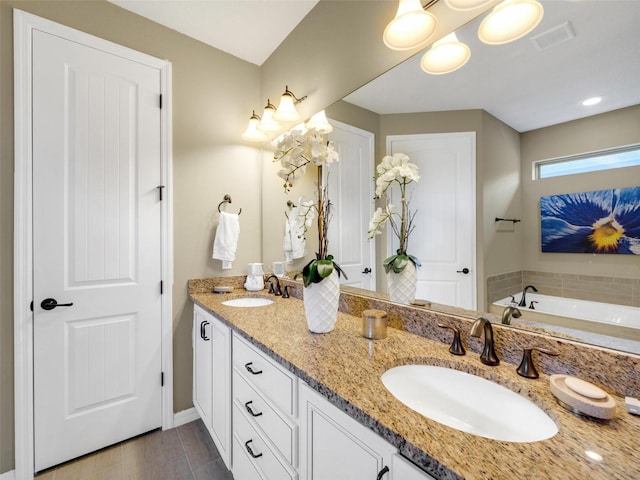 full bathroom featuring double vanity, a sink, visible vents, and a washtub