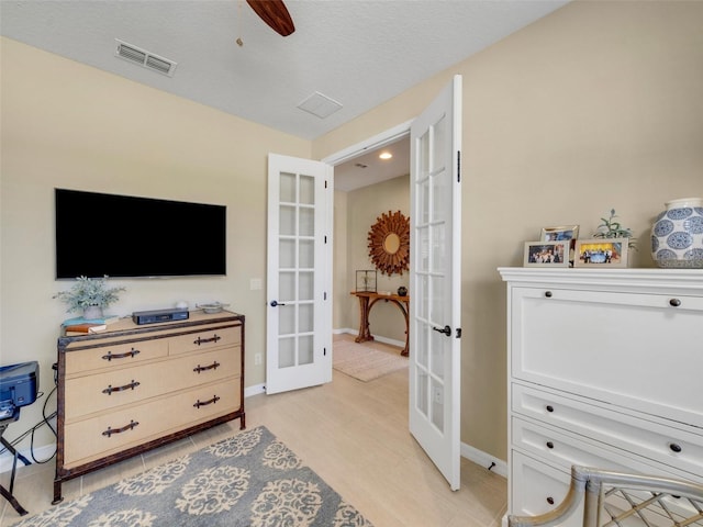 interior space featuring french doors, visible vents, ceiling fan, and baseboards