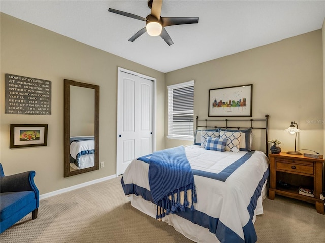 carpeted bedroom featuring a closet, a ceiling fan, and baseboards