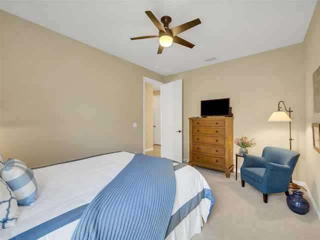 bedroom featuring ceiling fan, visible vents, baseboards, and light colored carpet