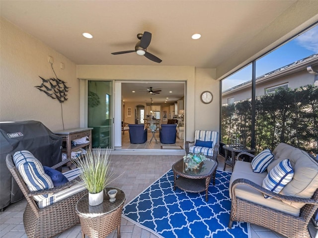 view of patio with a ceiling fan, fence, and an outdoor living space