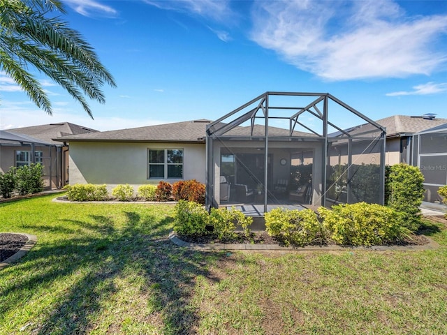 back of property featuring a lawn, a lanai, and stucco siding