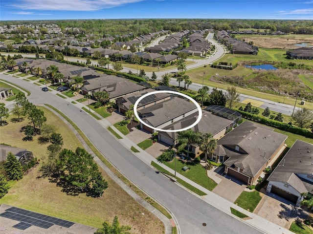 bird's eye view featuring a water view and a residential view