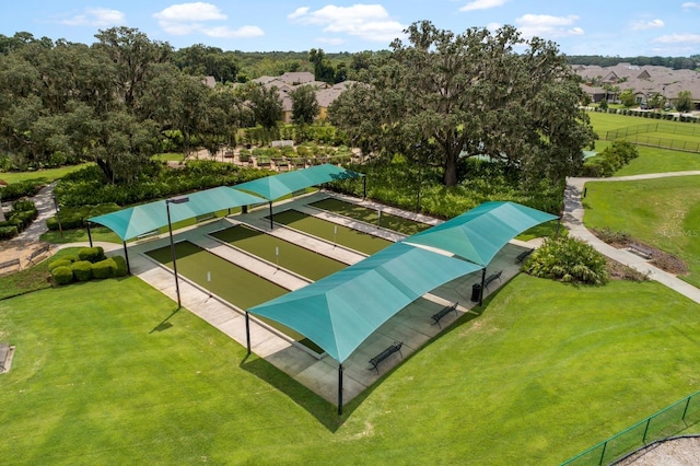 surrounding community with a lawn, fence, and a residential view