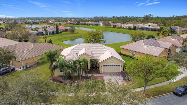 drone / aerial view featuring a residential view and a water view