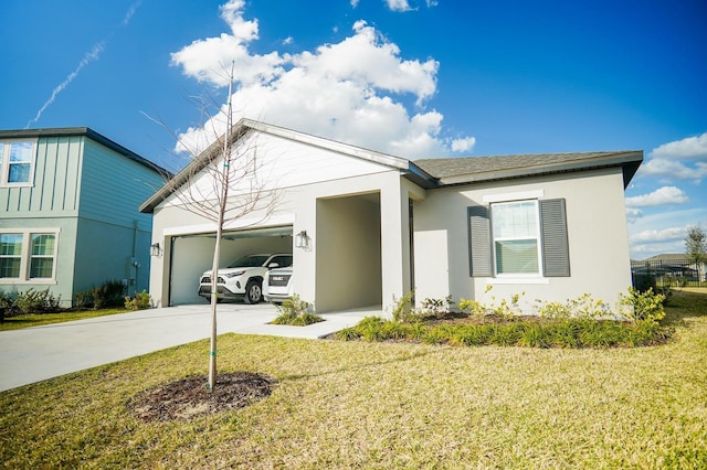 view of front of property featuring an attached garage, concrete driveway, roof with shingles, stucco siding, and a front yard