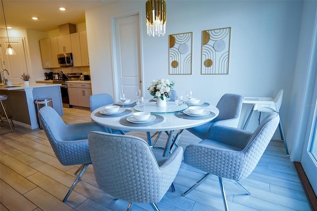 dining space with recessed lighting and light wood-style flooring