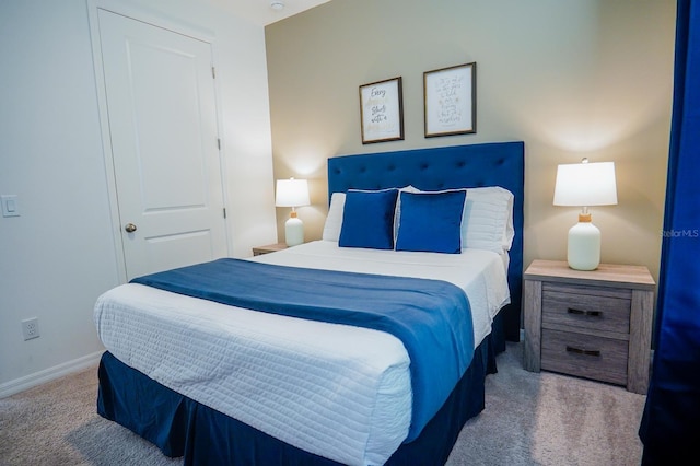 bedroom with carpet floors and baseboards