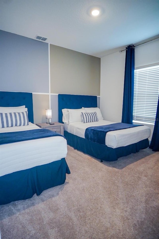 bedroom with carpet floors and visible vents