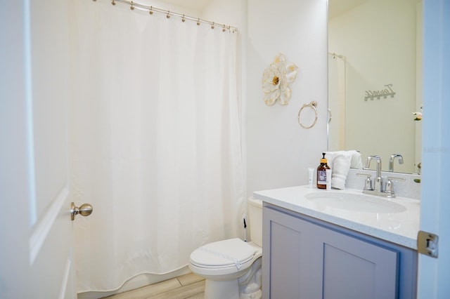 full bathroom with toilet, a shower with shower curtain, wood finished floors, and vanity